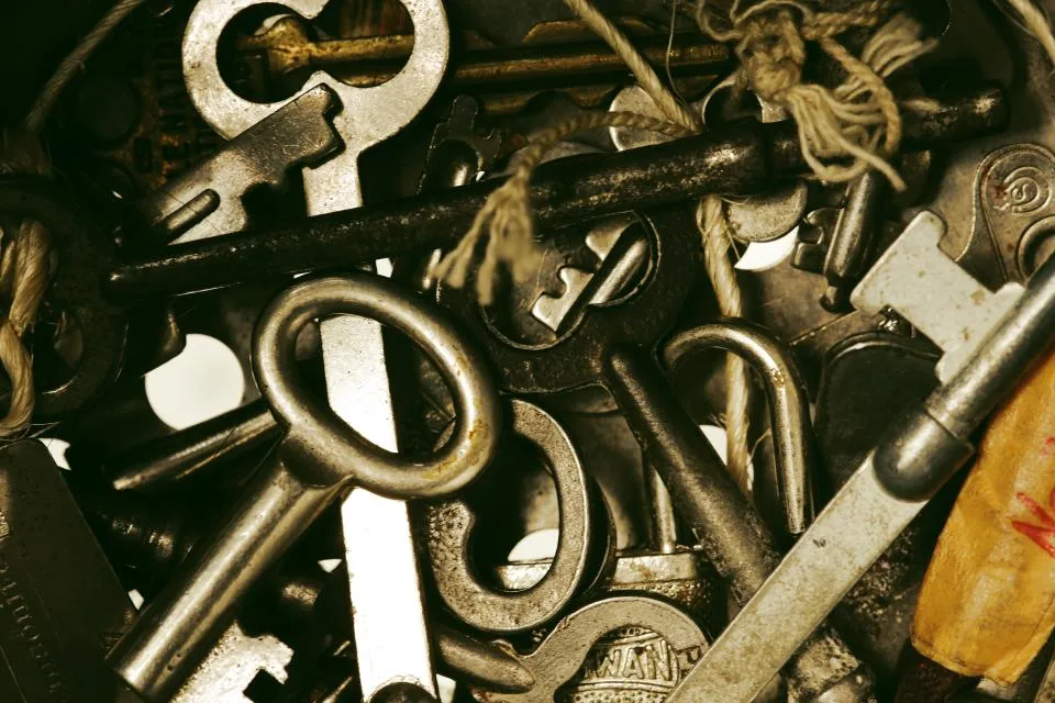A pile of old metal keys and padlocks