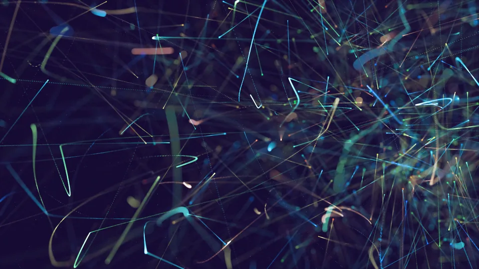 Abstract trails of coloured light on a dark background