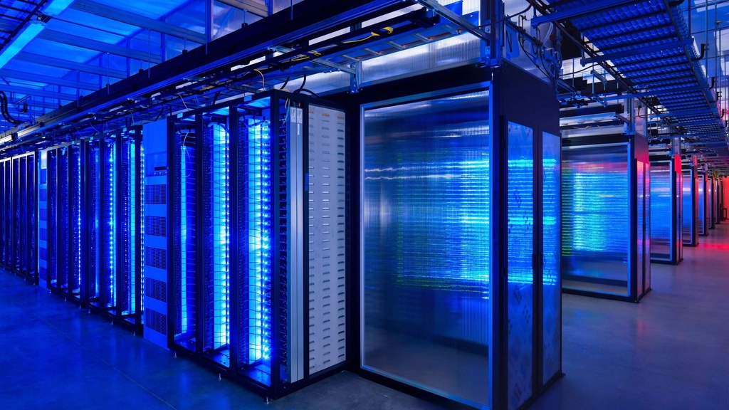 Rows of server cabinets glowing blue in a data center