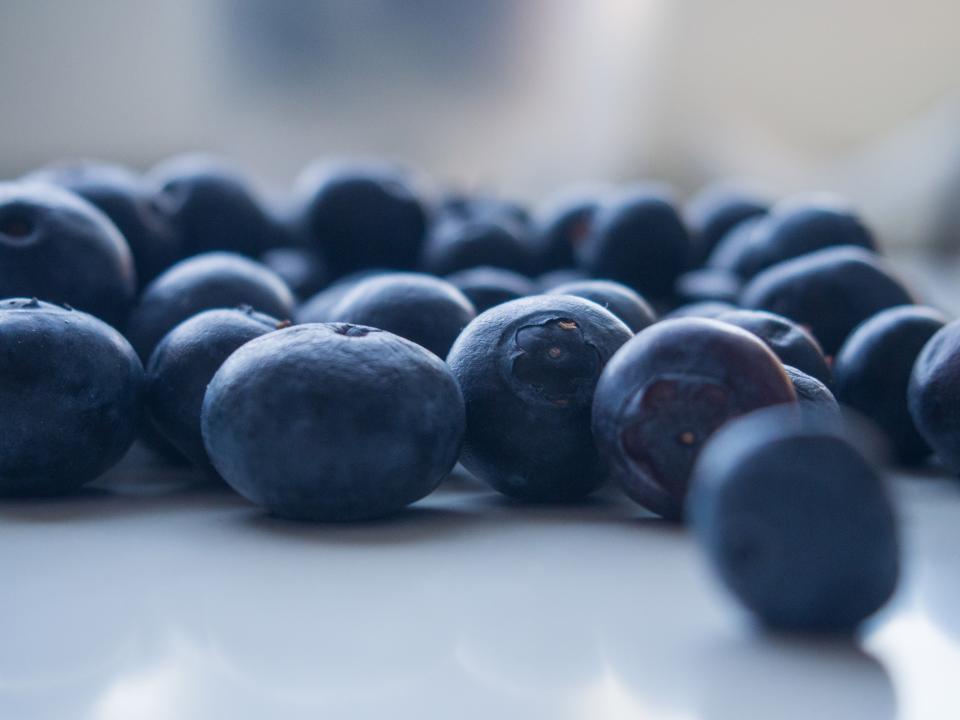 Fresh blueberries on a white surface