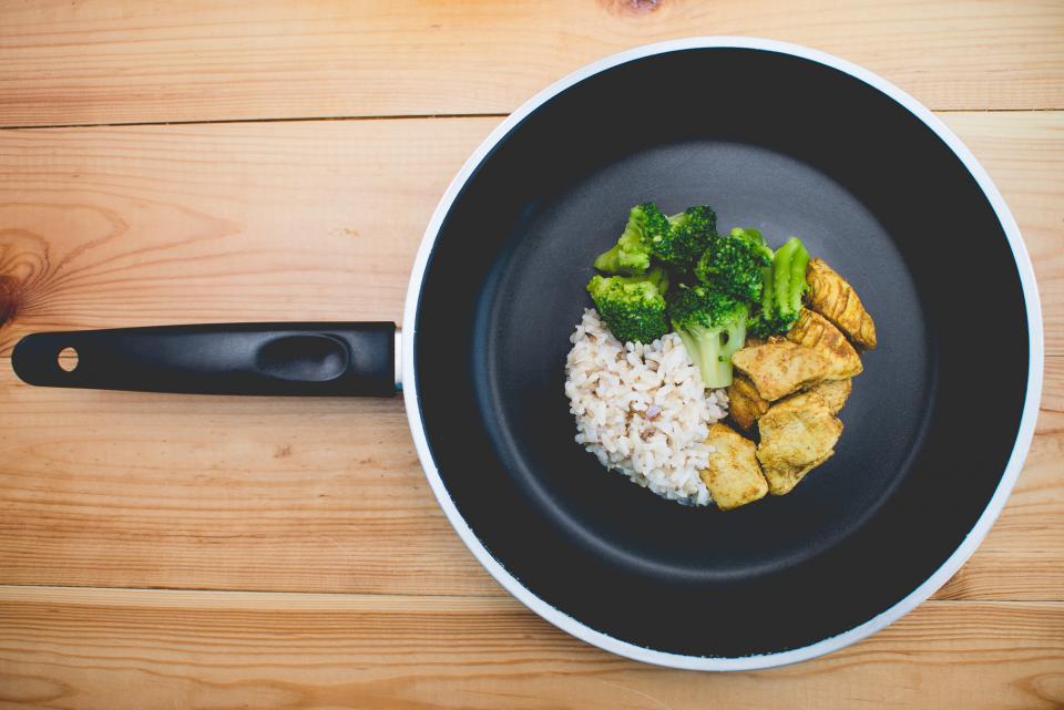 Home-cooked rice, broccoli and chicken in a frying pan