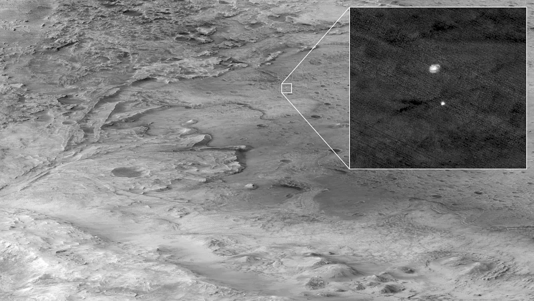 Black-and-white orbital view of Jezero Crater on Mars, with an inset showing the Perseverance rover descending under its parachute in 2021