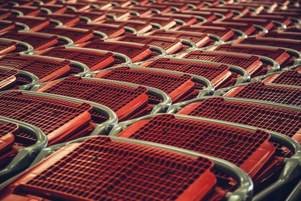 Rows of red shopping carts nested together at a store